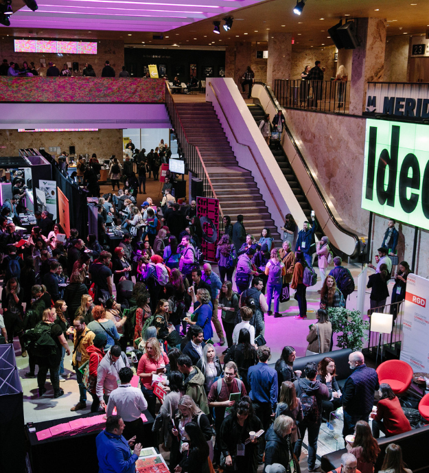 The atrium at DesignThinkers Toronto filled with people milling about.