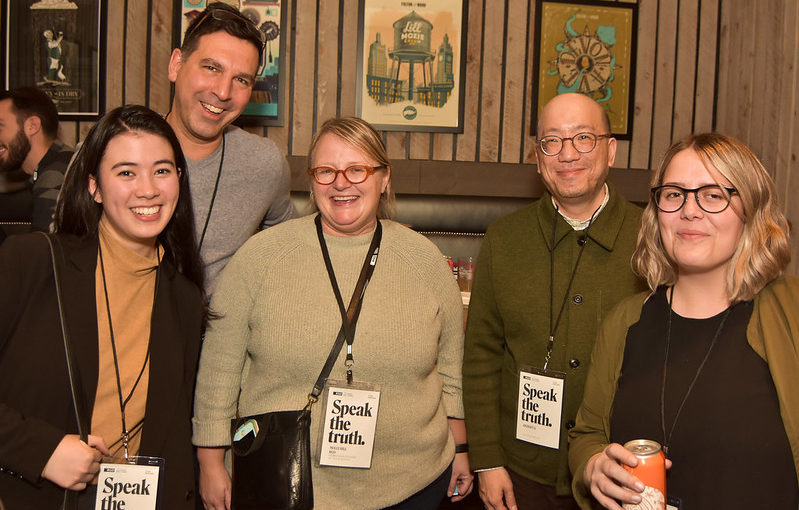 A group of five people smiling at the camera at DesignThinkers 2018.