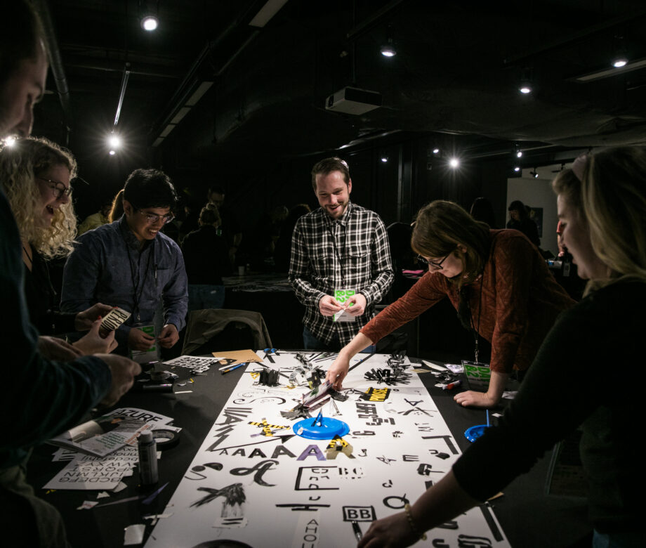 Group of persons around a table working on a typography workshop