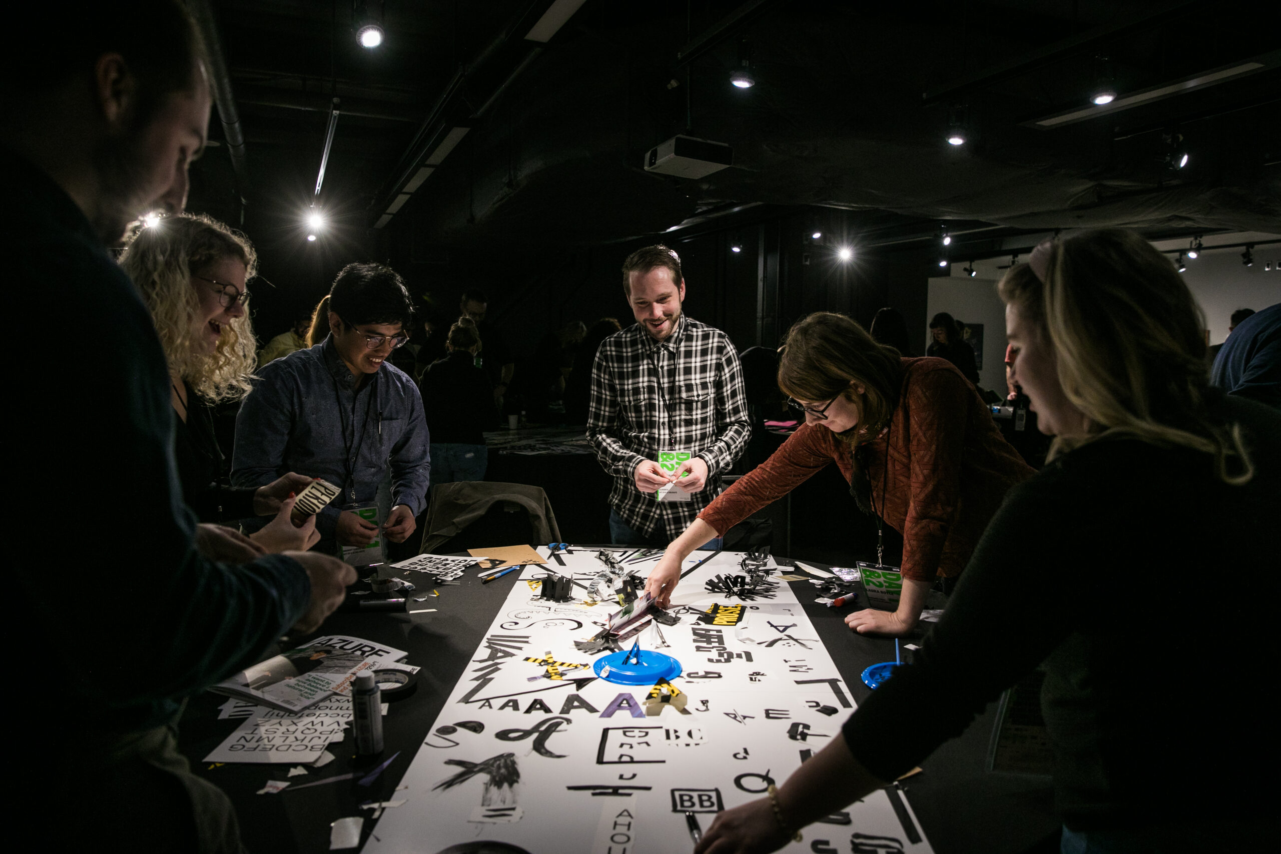 Group of persons around a table working on a typography workshop