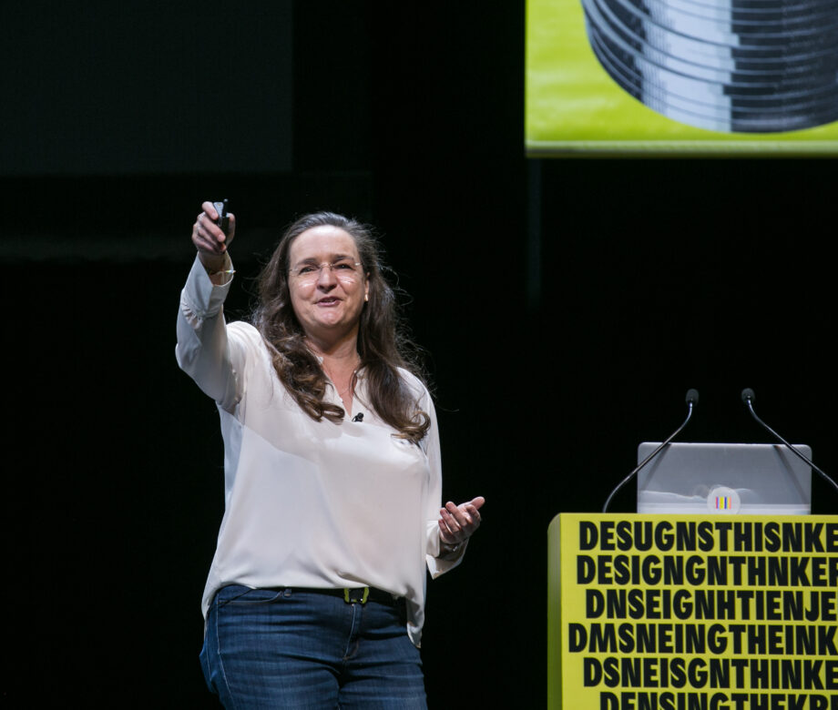 Lady speaking in front of a crowd