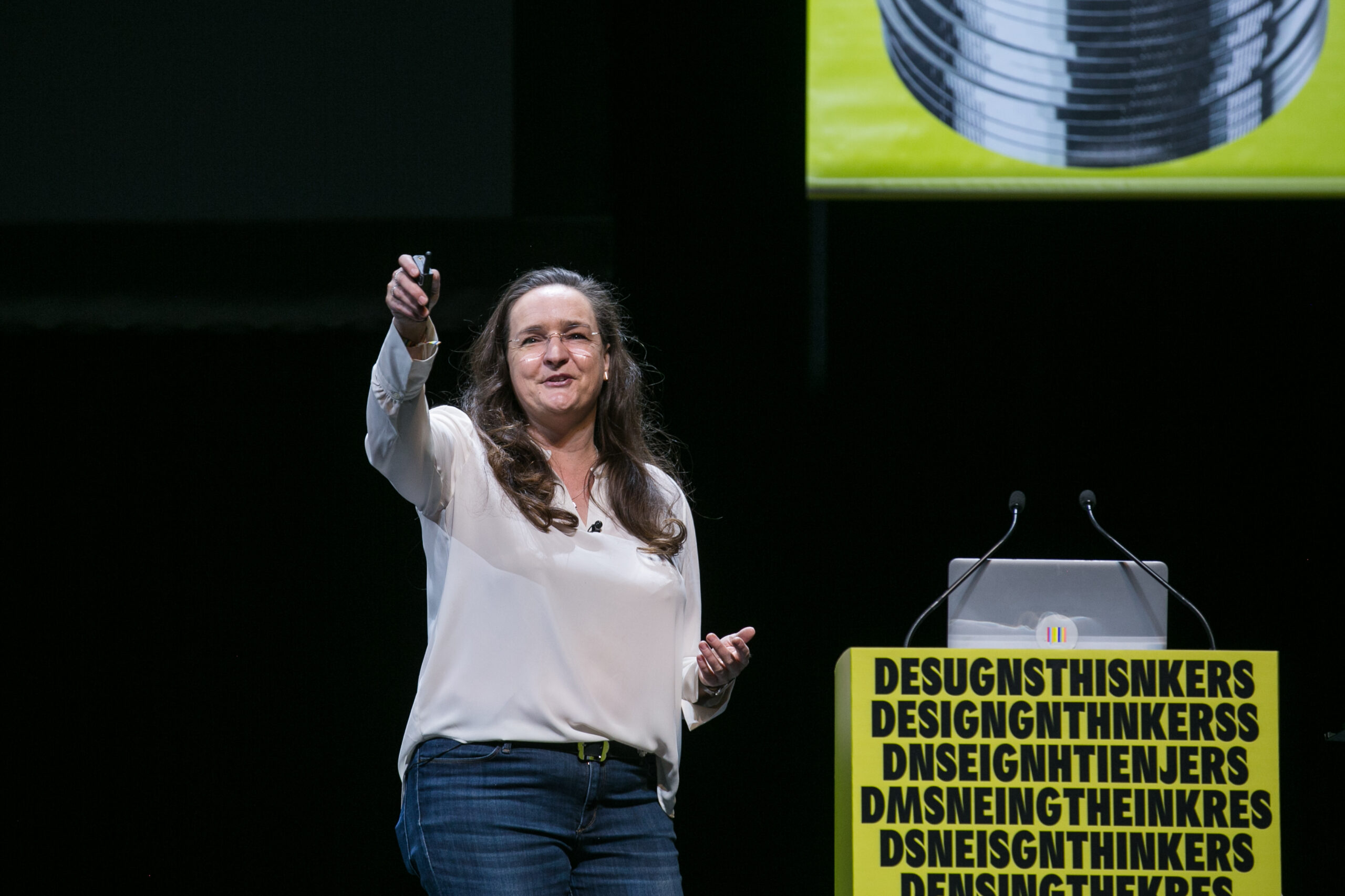 Lady speaking in front of a crowd